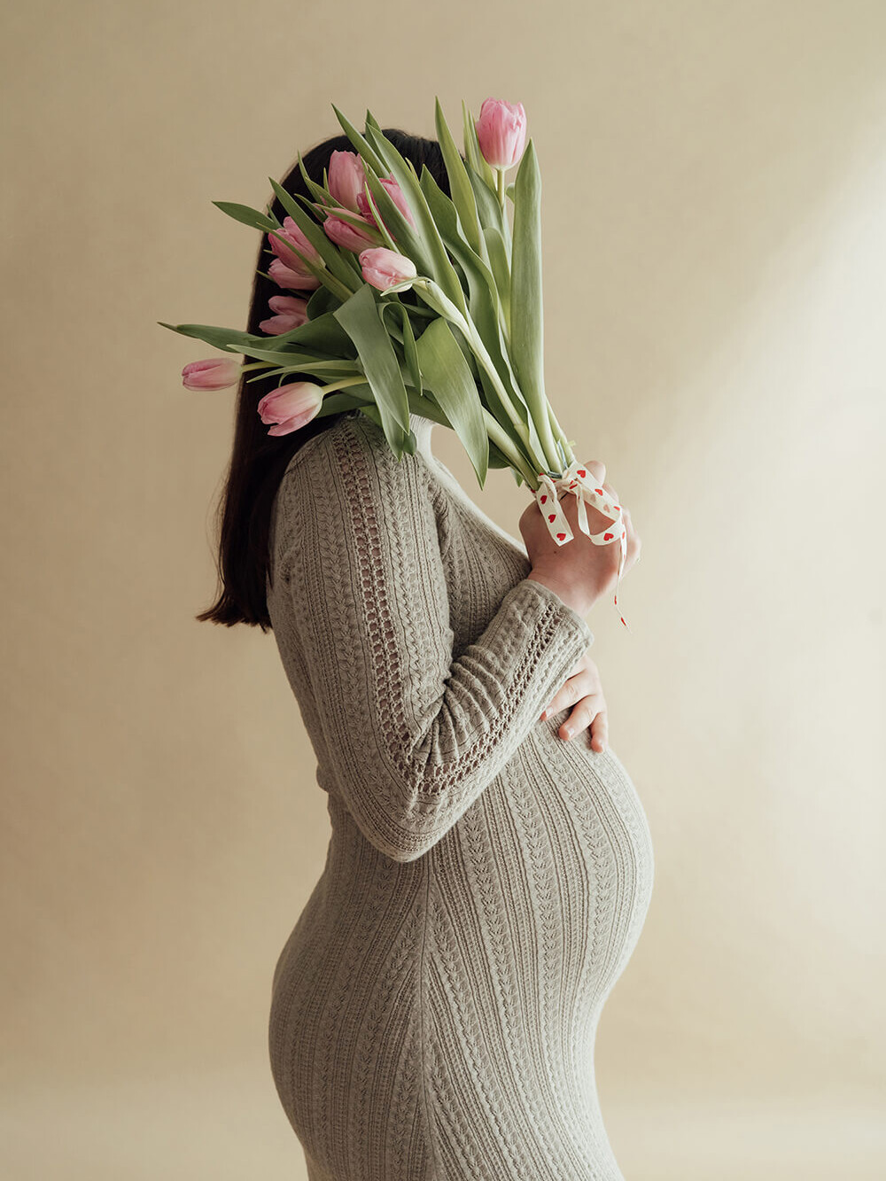editorial style maternity photo in a minimalist studio setting